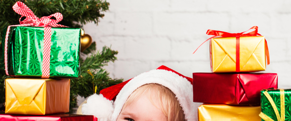 Child surrounded by Christmas presents