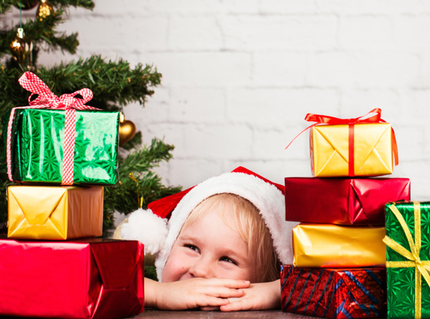 Child surrounded by Christmas presents