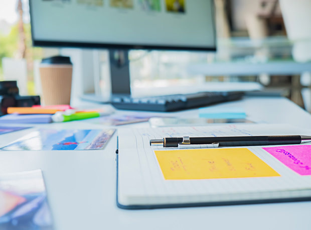 open book and computer at work desk
