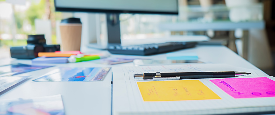 open book and computer at work desk