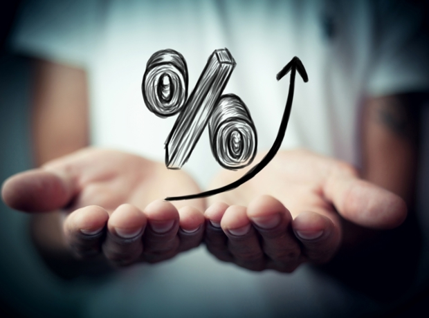 rising percentage sitting on top of pair of hands