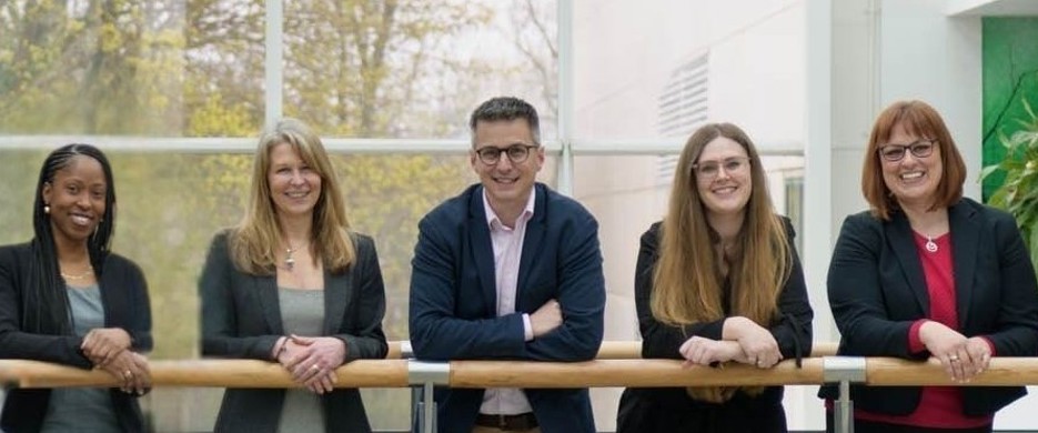 Team photo of staff on walkway