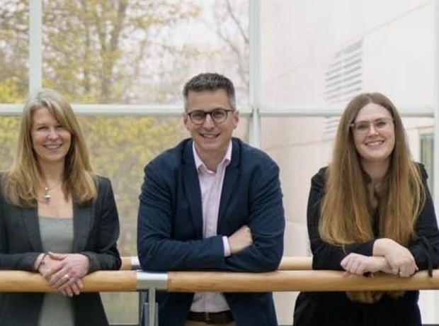 Team photo of staff on walkway