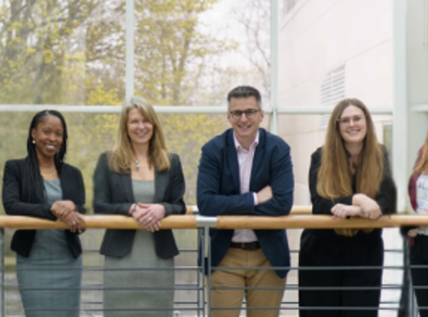 Team photo of staff on walkway