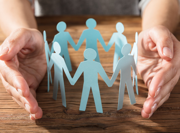hands around paper cut out people