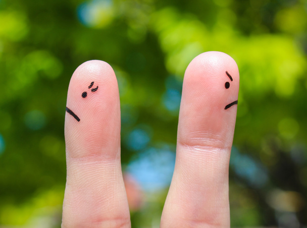 fingers with drawn faces facing away from each other