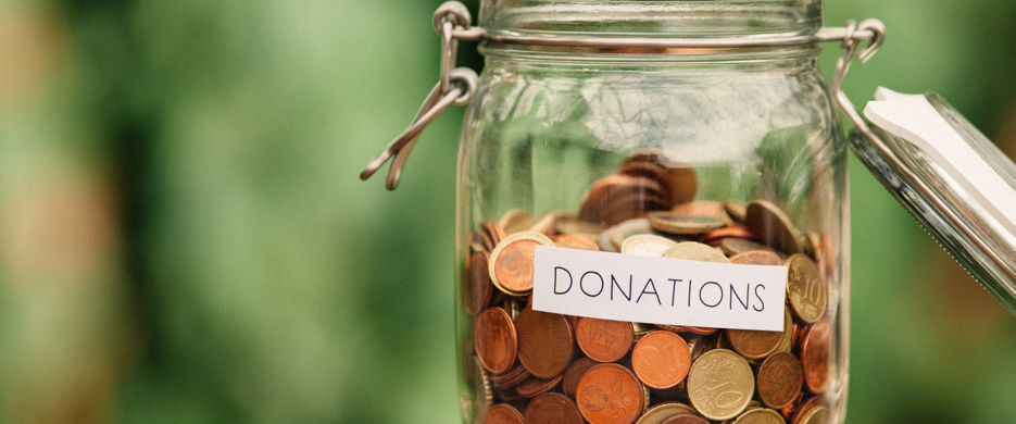 coins in a jar marked donations