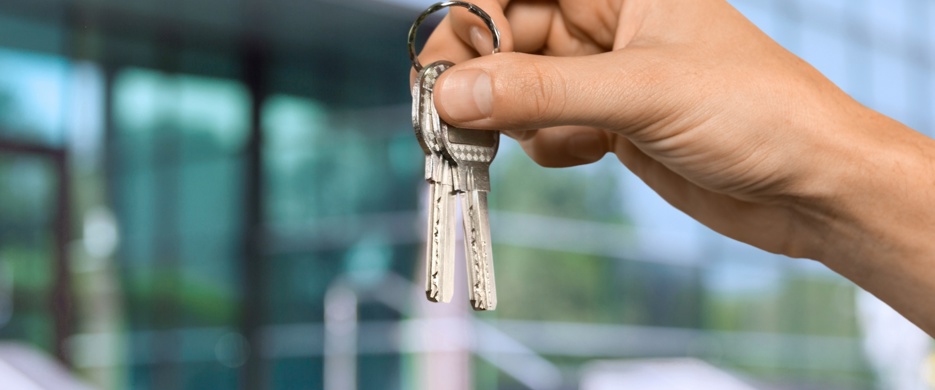 someone holding up two keys