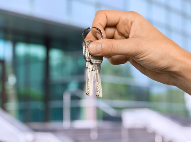 someone holding up two keys