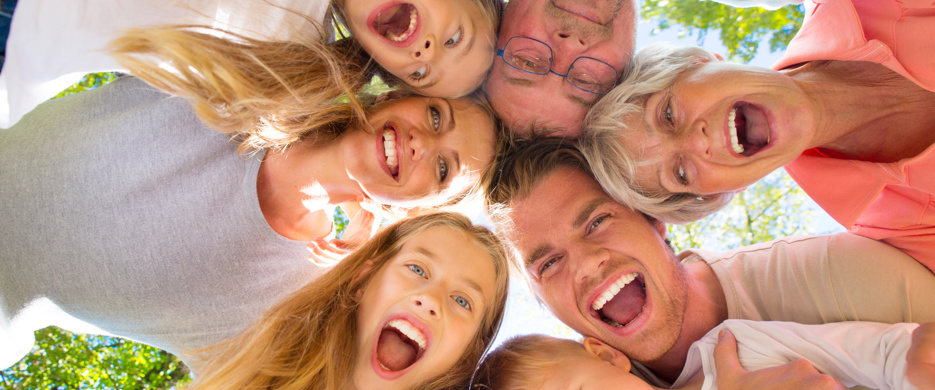 family group in circle looking down at camera