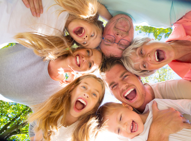 family group in circle looking down at camera
