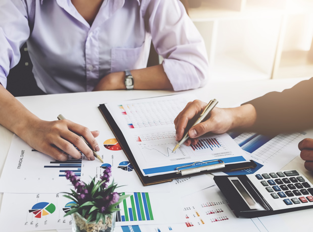 two business people looking at charts