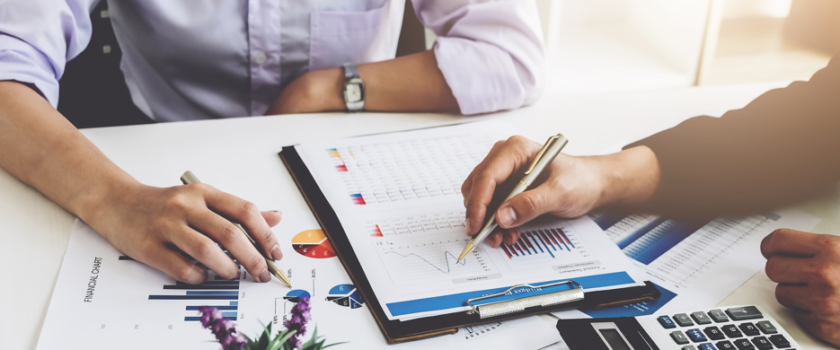 two business people looking at charts