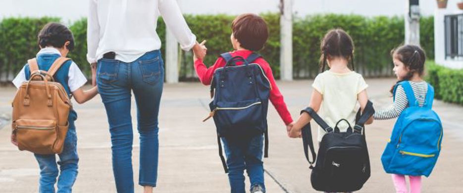 mother with four small children walking